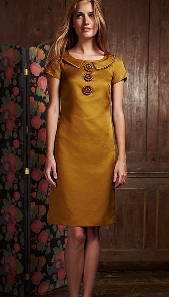 schmales goldfarbenes Kleid im Retro-Look mit kleinem Kragen und drei auffälligen Knöpfen